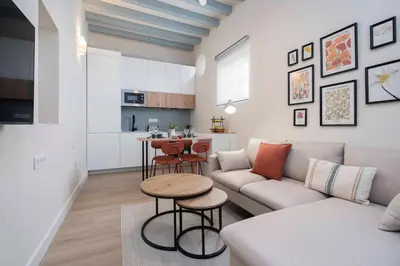 a living room with a couch and a table at Apartoyou - Centro Moderno in El Puerto de Santa María
