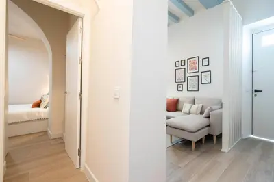a hallway with a living room with a couch at Apartoyou - Centro Moderno in El Puerto de Santa María