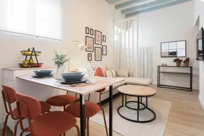 a kitchen with a table and chairs in a room at Apartoyou - Centro Moderno in El Puerto de Santa María