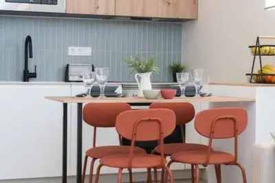 a kitchen with a table with chairs and wine glasses at Apartoyou - Centro Moderno in El Puerto de Santa María