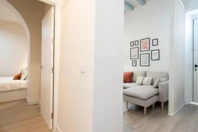 a white living room with a couch and a bed at Apartoyou - Centro Moderno in El Puerto de Santa María
