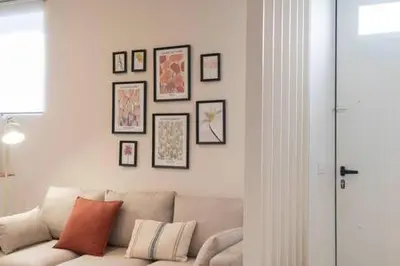 a living room with a couch and framed pictures on the wall at Apartoyou - Centro Moderno in El Puerto de Santa María