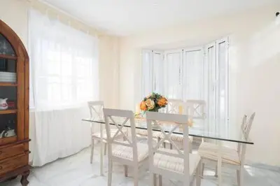 a dining room with a glass table and chairs at Apartoyou - Torre Vistahermosa in El Puerto de Santa María