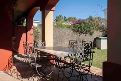 a table and chairs sitting on a patio at Apartoyou - Torre Vistahermosa in El Puerto de Santa María