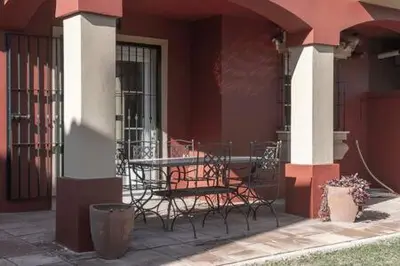 a table and chairs sitting outside of a building at Apartoyou - Torre Vistahermosa in El Puerto de Santa María