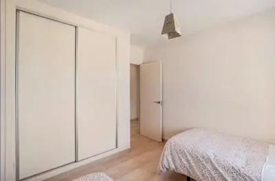 a bedroom with a large sliding glass door at Piso Cádiz Playa Victoria in Cádiz