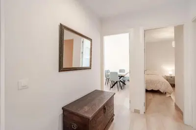 a room with a mirror and a table and a bed at Piso Cádiz Playa Victoria in Cádiz