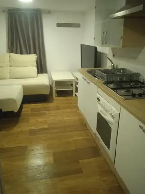 a kitchen with a stove and a couch in a room at Casita Playa Ballena in Rota