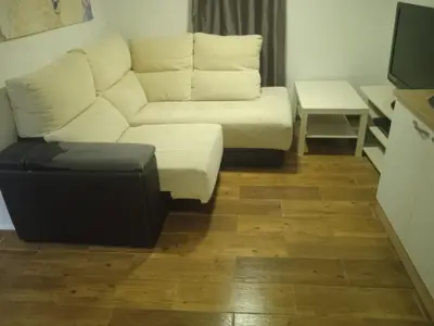 a living room with a white couch and a table at Casita Playa Ballena in Rota