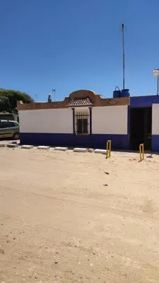 a blue and white building with a parking lot at Casita Playa Ballena in Rota