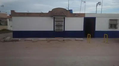 a blue and white building with a door at Casita Playa Ballena in Rota