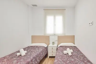 a bedroom with two beds and a window at Cádiz, ciudad y playa in Cádiz