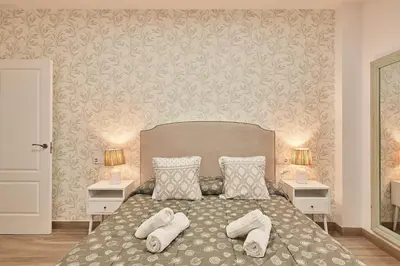 a bedroom with a bed with towels on it at Cádiz, ciudad y playa in Cádiz