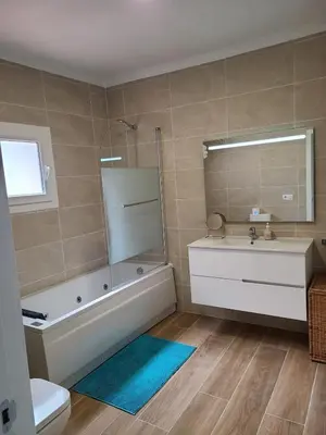 a bathroom with a tub and a sink and a toilet at Villa Serena - Casa rural en Arcos con piscina, barbacoa, chimenea in Arcos de la Frontera