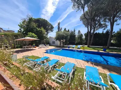 a swimming pool with blue chairs and a swimming pool at Villa Serena - Casa rural en Arcos con piscina, barbacoa, chimenea in Arcos de la Frontera