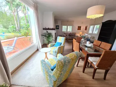 a living room with chairs and a table and a dining room at Villa Serena - Casa rural en Arcos con piscina, barbacoa, chimenea in Arcos de la Frontera