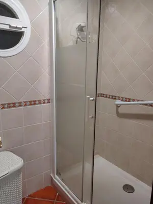a shower with a glass door in a bathroom at Villa con piscina junto a la playa in Roche