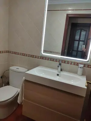 a bathroom with a toilet and a sink and a mirror at Villa con piscina junto a la playa in Roche