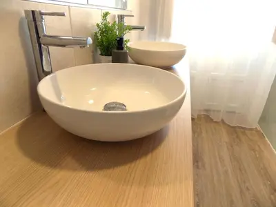 a bathroom with a white bowl sink on a counter at Plaza del Rey Apartments in San Fernando