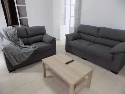 a living room with two couches and a coffee table at Plaza del Rey Apartments in San Fernando