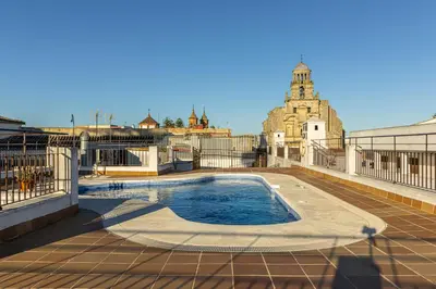 a swimming pool on the roof of a building at Allo Apartments San Lucas Parking Piscina Centro 2 habitaciones in Jerez de la Frontera