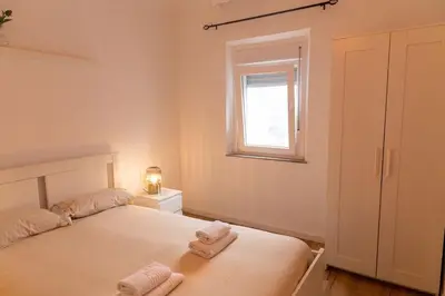 a bedroom with a bed with two towels on it at El Ático de la Palma by Gades Gestión in Cádiz