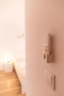 an open door with a light switch on a wall at El Ático de la Palma by Gades Gestión in Cádiz