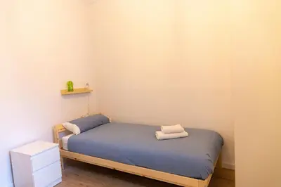 a small room with a bed with two towels on it at El Ático de la Palma by Gades Gestión in Cádiz