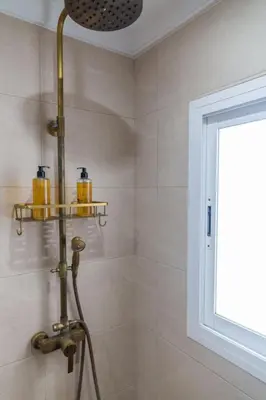 a shower in a bathroom with a shower head at El Ático de la Palma by Gades Gestión in Cádiz