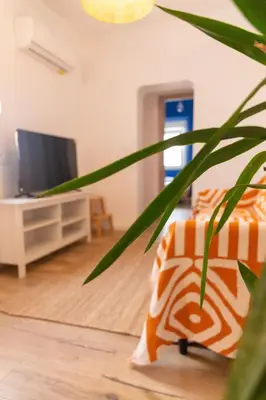 a living room with a couch and a tv at El Ático de la Palma by Gades Gestión in Cádiz