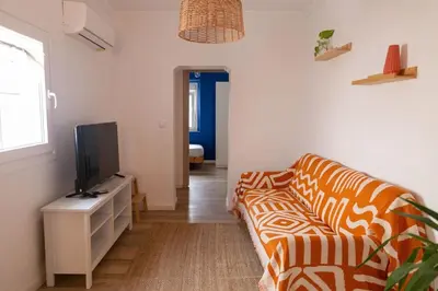 a living room with a couch and a tv at El Ático de la Palma by Gades Gestión in Cádiz