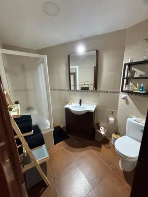 a bathroom with a sink and a toilet and a mirror at Casa Azacanes in Sanlúcar de Barrameda
