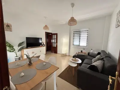 a living room with a couch and a table at Casa Azacanes in Sanlúcar de Barrameda