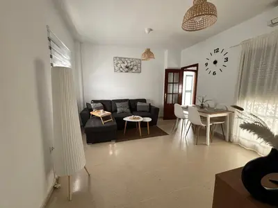 a living room with a couch and a table at Casa Azacanes in Sanlúcar de Barrameda