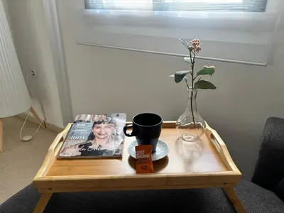 a coffee table with a magazine and a vase on it at Casa Azacanes in Sanlúcar de Barrameda