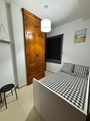 a bedroom with a bed and a flat screen tv at Casa Azacanes in Sanlúcar de Barrameda