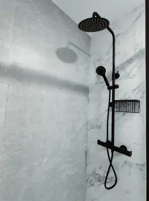 a shower with a shower head in a bathroom at Amber Suite in Jerez de la Frontera