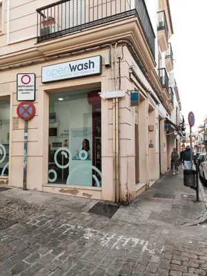 an open wash sign in a store window on a street at Amber Suite in Jerez de la Frontera