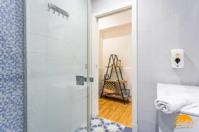 a bathroom with a shower with a glass door at Apartamento El Patio by Cadiz Time in Cádiz