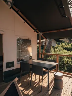 a black table and chairs on a deck at wecamp Cádiz in Cádiz