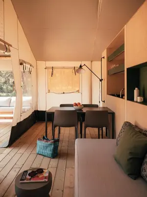 a living room with a table and chairs in a caravan at wecamp Cádiz in Cádiz