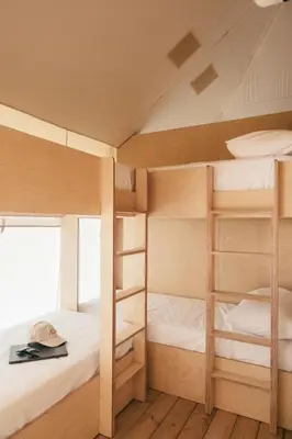 two bunk beds in a room with wooden floors at wecamp Cádiz in Cádiz