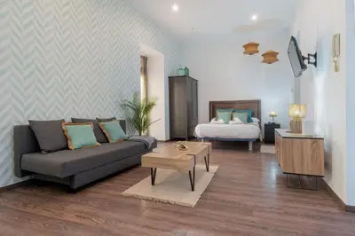 a living room with a couch and a bed at Panther Home Aladro II in Jerez de la Frontera