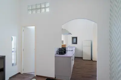 a kitchen with white appliances and an archway at Panther Home Aladro II in Jerez de la Frontera