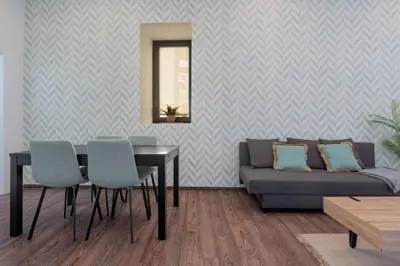 a living room with a table and a couch at Panther Home Aladro II in Jerez de la Frontera