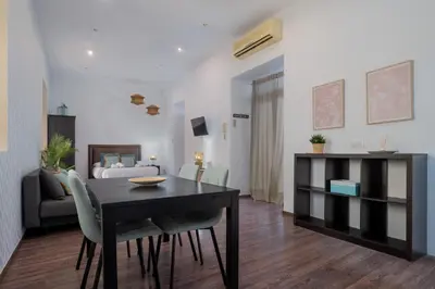 a living room with a dining table and a bedroom at Panther Home Aladro II in Jerez de la Frontera