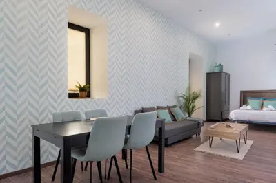a living room with a dining table and a couch at Panther Home Aladro II in Jerez de la Frontera