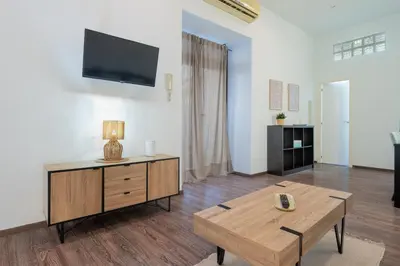 a living room with a table and a tv at Panther Home Aladro II in Jerez de la Frontera