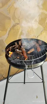 a grill with a bunch of food cooking on it at Como en casa in Jerez de la Frontera