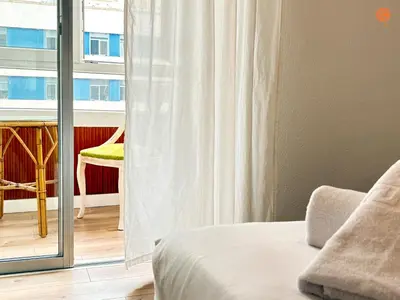 a bedroom with a bed and a window with a chair at Mar de Viya Grupo AC Gestion in Cádiz